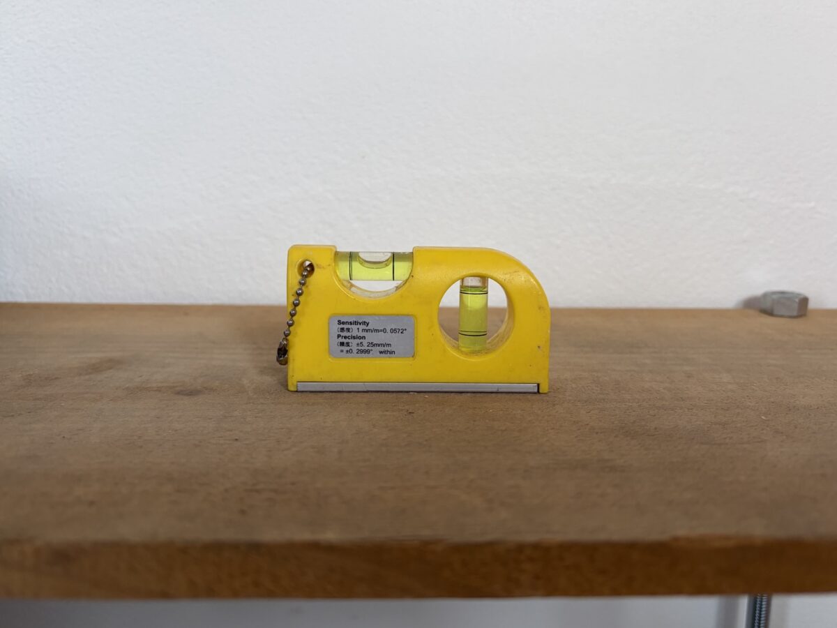 水平器で棚の水平を確認する様子